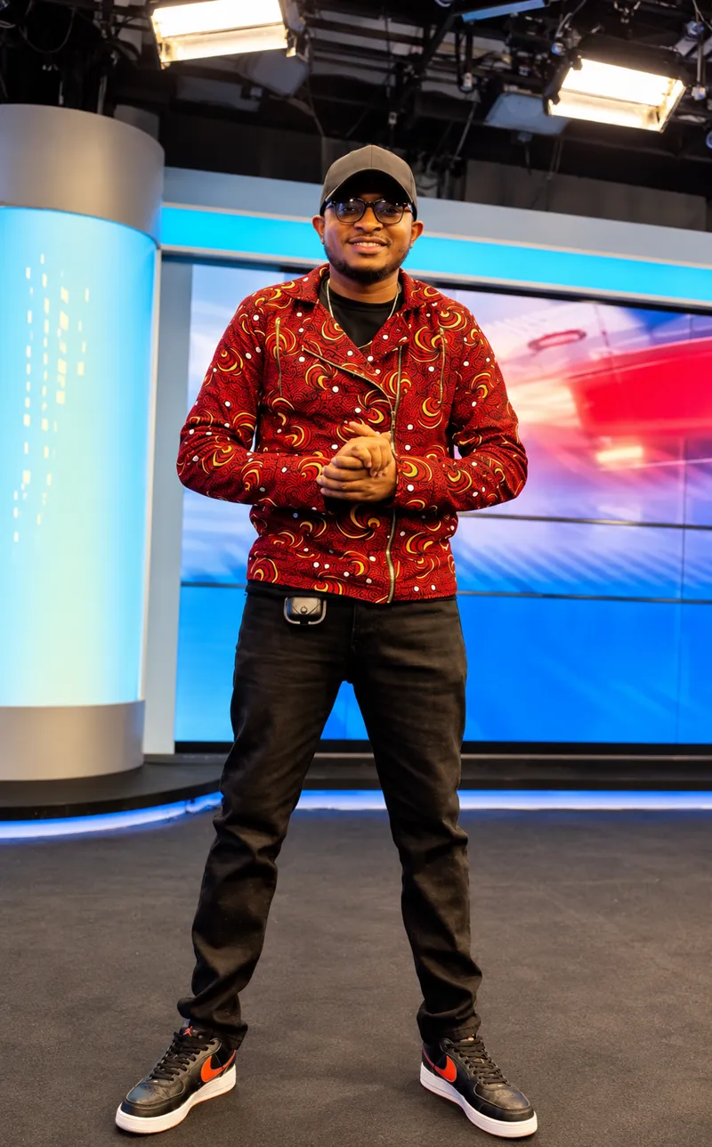 Customer in a red print shirt and black cap in a television studio